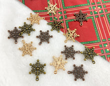 Load image into Gallery viewer, 23x25mm Pewter Christmas Snowflake Charm Xmas Holiday Winter Charm in Rosy Gold, Antique Copper and Brass | Bulk Option Available
