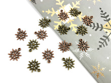 Load image into Gallery viewer, 17mm Pewter Christmas Snowflake Charm Holiday Charm in Antique Copper and Brass | Bulk Option Available
