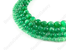 Load image into Gallery viewer, Faceted Round Cat&#39;s Eye Dyed Green Beads Around 15&quot;
